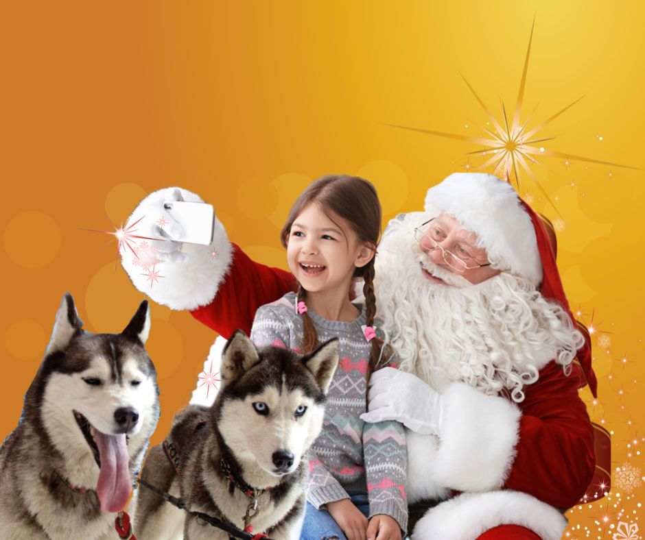 Santa a child and huskies